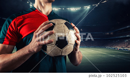 Confident soccer player ready to play holds the ball in his hands at the stadium. Generative AI 102525103