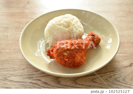 crispy fried salty chicken drumstick eat with sticky rice on plate crispy fried salty chicken drumstick eat with sticky rice on plate 102525127