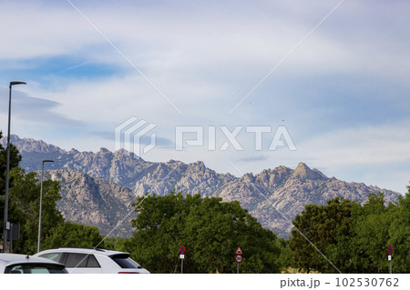 Mountains. Views of some rocky mountains with a field full of green trees and land with a cloudy sky. Horizontal photography. Mountains. Views of some rocky mountains with a field full of green trees and land with a cloudy sky. Horizontal photography. 102530762