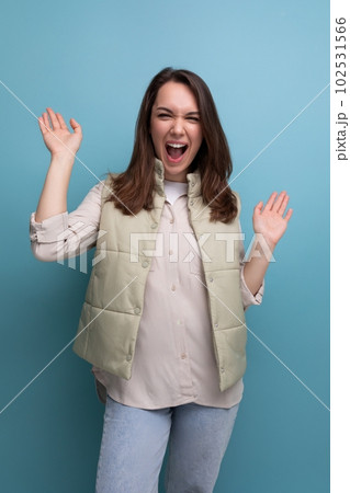 positive cheerful black-haired young lady in casual clothes over isolated background positive cheerful black-haired young lady in casual clothes over isolated background 102531566