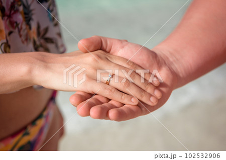 Man and woman, newlyweds holding hands with blurred background. Man and woman, newlyweds holding hands with blurred background. 102532906