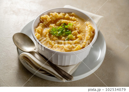 Root mash. Root vegetables mashed in a bowl. Garnished with oil and herbs. 102534079