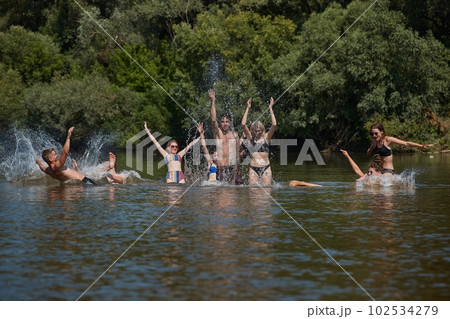 Group of young people fun on the beach, river water Group of young people fun on the beach, river water 102534279