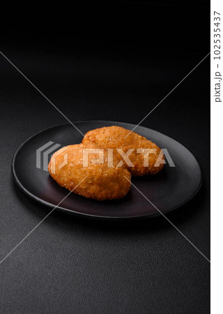 Delicious baked cutlet breaded with spices, salt and herbs Delicious baked cutlet breaded with spices, salt and herbs 102535437