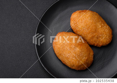 Delicious baked cutlet breaded with spices, salt and herbs 102535438