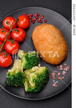Delicious baked cutlet breaded with spices, salt and herbs Delicious baked cutlet breaded with spices, salt and herbs 102535482