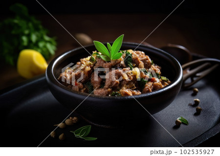 AI generated appetizing Pork Sisig in a dark green bowl 102535927