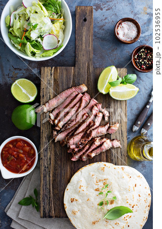 Cooking steak tacos with sliced meet 102536955