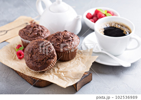 Chocolate muffins with a cup of coffee 102536989