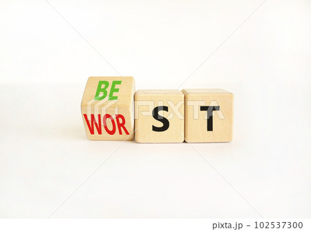 Best or worst symbol. Businessman turns wooden cubes and changes the word best to worst. Beautiful white table white background, copy space. Business and best or worst concept. 102537300