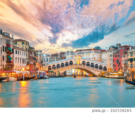 Amazing sunset and evening cityscape of Venice with famous Canal Grande and Rialto Bridge Amazing sunset and evening cityscape of Venice with famous Canal Grande and Rialto Bridge 102538263