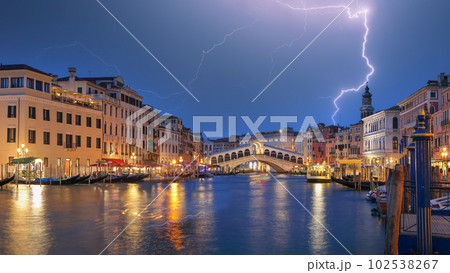 Stunning lightning at night sky over city of f Venice with famous Canal Grande and Rialto Bridge 102538267