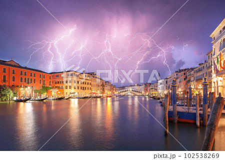 Stunning lightning at night sky over city of f Venice with famous Canal Grande and Rialto Bridge 102538269