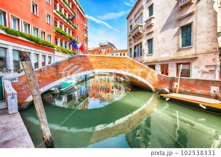 Fabulous cityscape of Venice with narrow canals, boats and gondolas and bridges with traditional buildings Fabulous cityscape of Venice with narrow canals, boats and gondolas and bridges with traditional buildings 102538331