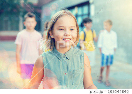 Joyful preteen girl walking along city street on summer day Joyful preteen girl walking along city street on summer day 102544846