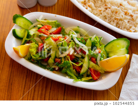 Choban salad from tomatoes, cucumbers, greens, onions with lemon Choban salad from tomatoes, cucumbers, greens, onions with lemon 102544855