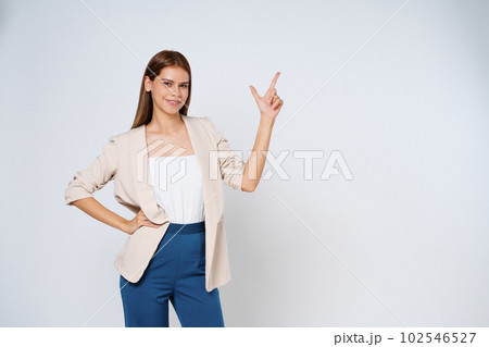 Young woman pointing to empty copy space isolated on white background. Young woman pointing to empty copy space isolated on white background. 102546527