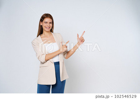 Young woman pointing to empty copy space isolated on white background. Young woman pointing to empty copy space isolated on white background. 102546529