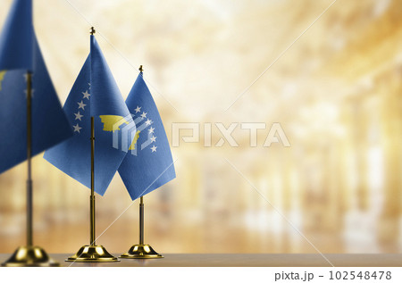 Small flags of the Kosovo on an abstract blurry background 102548478