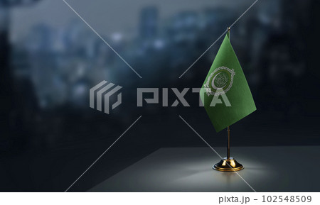 A small Arab League flag on an abstract blurry background A small Arab League flag on an abstract blurry background 102548509