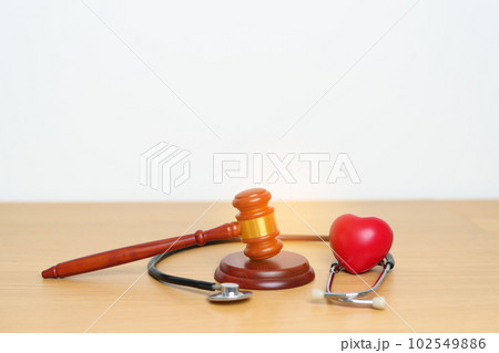Gavel and stethoscope on table. Medical and Health Law, legal of medical malpractice concept 102549886