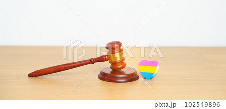 Pansexual Pride Day, LGBTQ Law and Pride month concepts. gavel justice hammer with pink, yellow and blue heart shape for Lesbian, Gay, Bisexual, Transgender, Queer, Intersex 102549896