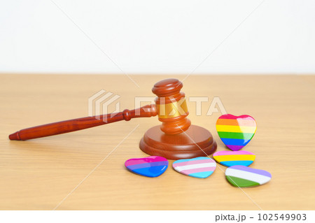 LGBT Law and Pride month concepts. gavel justice hammer with rainbow colorful heart shape for Lesbian, Gay, Bisexual, Transgender, Queer, Intersex, Asexual, Agender, Non Binary, Two Spirit, Pansexual 102549903