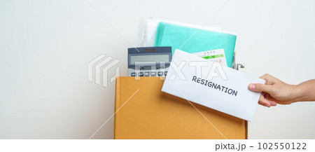 Resignation, Layoff, Unemployment, Dismiss, Job quit, Jobless and Farewell concept. Businesswoman holding letter of Resign contract with documents cardboard box at office 102550122