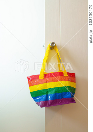 LGBT pride month concept or LGBTQ+ or LGBTQIA+,Eco friendly bag with rainbow color hanging on the door. LGBT pride month concept or LGBTQ+ or LGBTQIA+,Eco friendly bag with rainbow color hanging on the door. 102550479