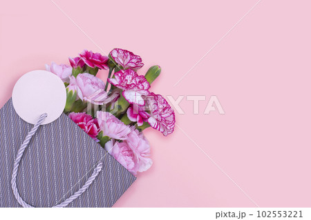 Bouquet of carnations in a shopping bag 102553221
