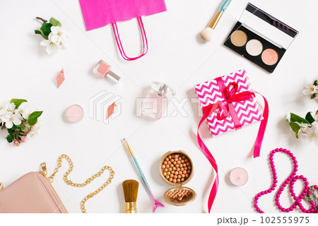 Beautiful layout on a white background. Cosmetics, apple tree flowers. Flat layout, space for copying. Fashion concept. 102555975