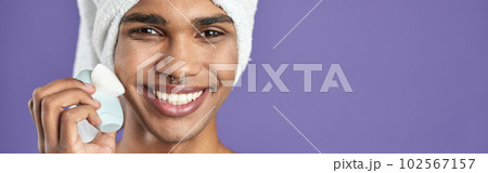 Afroamerican transgender young man looking camera and smile in towel. Trans gender male skin care 102567157