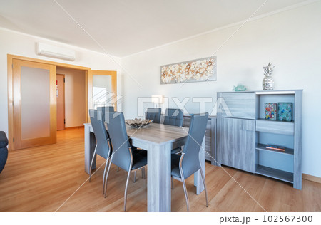 A cozy European living room with a dinner table and interior decorations. A cozy European living room with a dinner table and interior decorations. 102567300