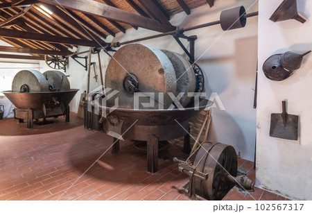 Olive oil press is installed in premises of ancient equipment for production of olive oil, stone mill and mechanical press, olive oil mill. Olive oil press is installed in premises of ancient equipment for production of olive oil, stone mill and mechanical press, olive oil mill. 102567317