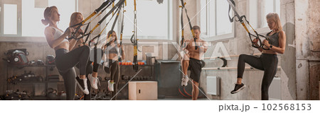Athletic people doing crossfit training in gym Athletic people doing crossfit training in gym 102568153