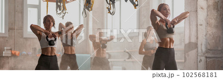 Caucasian young people exercising in fitness center Caucasian young people exercising in fitness center 102568181