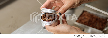 Male hands holding metal container with coffee beans Male hands holding metal container with coffee beans 102568225