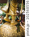 People attached gold leaf to the statue of Buddha 102568556