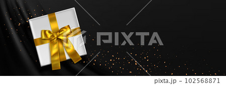 3d gift box with gold ribbon on black silk fabric 102568871