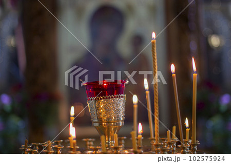 Church candles on the background of icons. Religion. Church candles on the background of icons. Religion. 102575924
