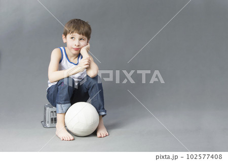 A child with a soccer ball. The boy dreams of becoming a football player A child with a soccer ball. The boy dreams of becoming a football player 102577408