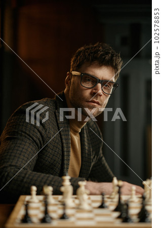 Portrait of man chess player with chessboard 102578853