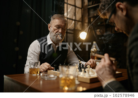 Family of intelligent people playing chess, smoking cigars and drinking whiskey 102578946