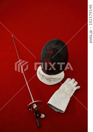 Fencing equipment concept, crossed swords and protective helmet with mask Fencing equipment concept, crossed swords and protective helmet with mask 102579146
