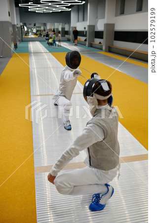Duel of fencers during fencing match, training lesson at martial art class 102579199