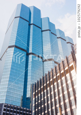Morning sunlight reflecting on shiny windows of blue building. Morning sunlight reflecting on shiny windows of blue building. 102579292