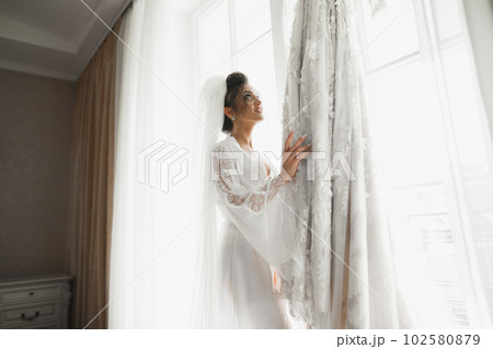 Portrait of beautiful bride with fashion veil at wedding morning Portrait of beautiful bride with fashion veil at wedding morning 102580879