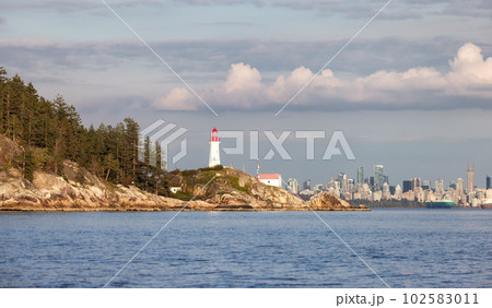 Lighthouse park on Rocky Shore with Downtown City in Background. 102583011