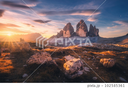 Rocks and stones at colorful sunset in autumn in Tre Cime 102585361