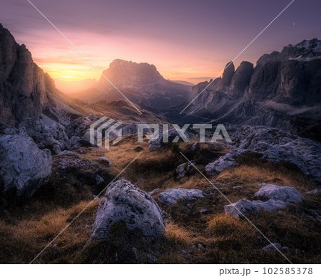 Mountain valley at colorful sunset in autumn in Dolomites, Italy 102585378
